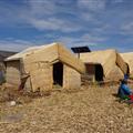 Huts on the floating islands, one with a solar panel